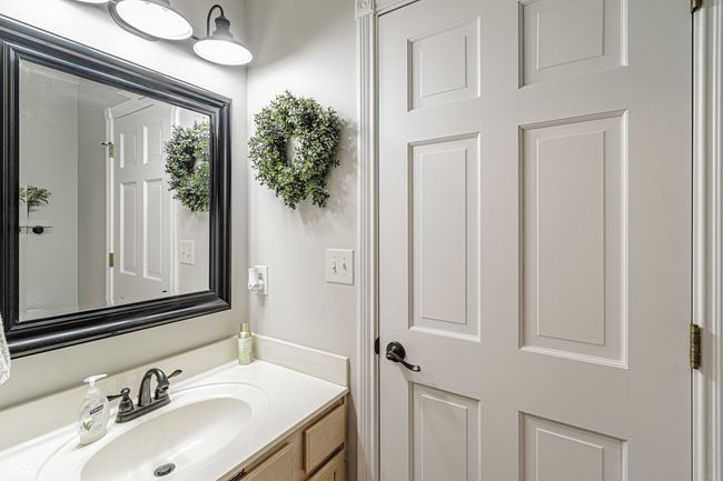 Half bathroom featuring vanity inside laundry area | Image 22