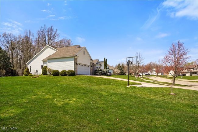 View of home's exterior featuring a garage, a yard, and concrete driveway | Image 7