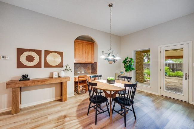 Dining space featuring light wood-style flooring and a chandelier | Image 22