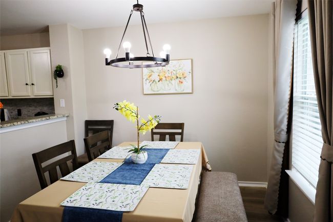 Dining room featuring an inviting chandelier, baseboards, and dark wood finished floors | Image 5