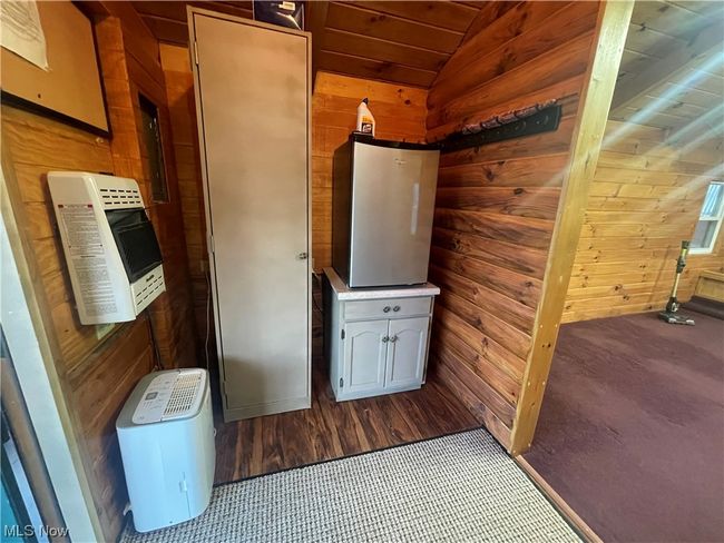 Laundry area with wood ceiling and wood walls | Image 37