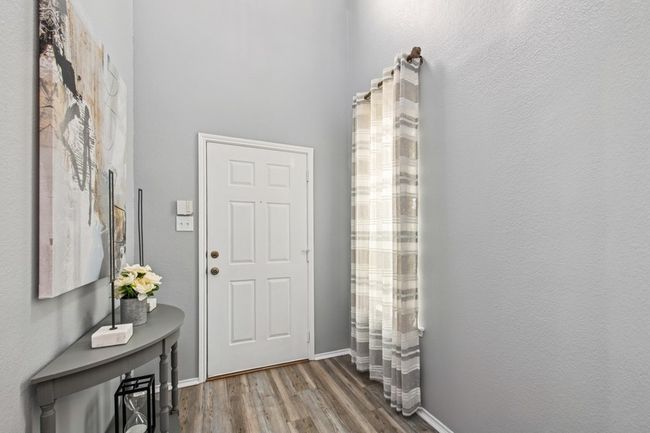 Entryway featuring baseboards and wood finished floors | Image 9
