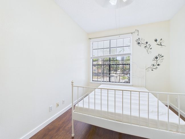 Unfurnished bedroom with wood finished floors and baseboards | Image 20