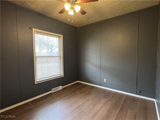 Spare room with wood-type flooring and ceiling fan | Image 13