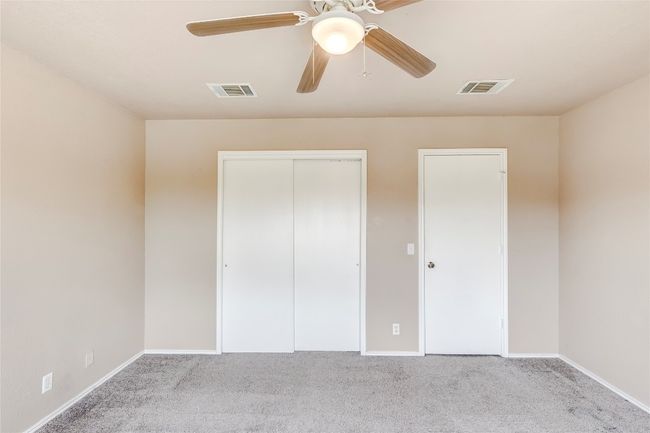Unfurnished bedroom featuring carpet and ceiling fan | Image 14
