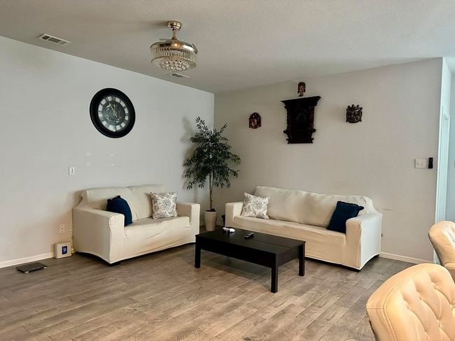 Living room featuring light wood-style flooring and baseboards | Image 5