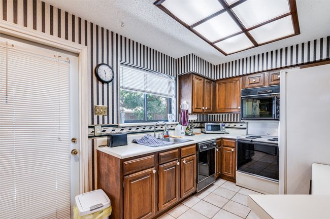 Kitchen with door leading to large outdoor patio / Balcony | Image 11