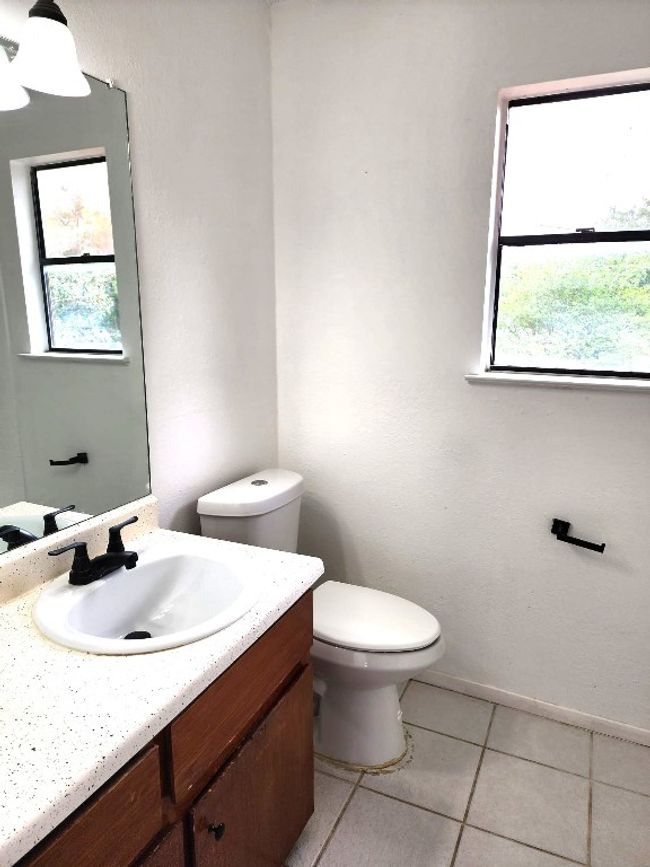 Bathroom with vanity, plenty of natural light, and tile patterned floors | Image 7