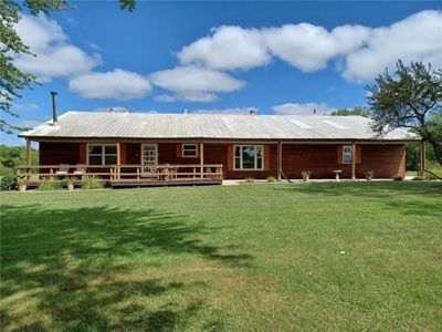 Back of house featuring a wooden deck and a lawn | Image 1