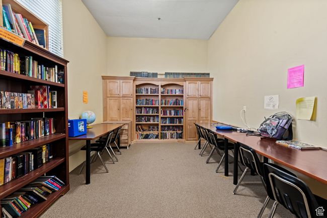 Office area featuring bookshelves and light carpet | Image 33