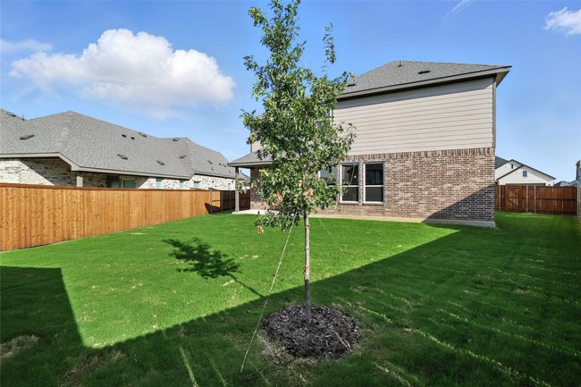 Rear view of property with brick siding and a fenced backyard | Image 29