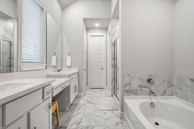 Primary ensuite with shower with separate bathtub, lofted ceiling, and vanity | Image 17