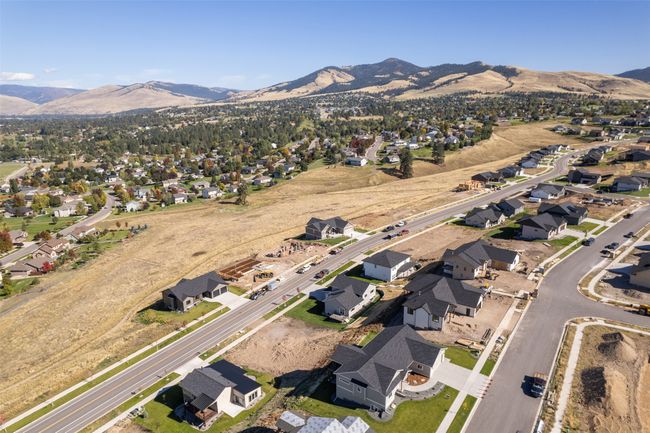 Aerial overview of property's location with a mountain backdrop and nearby suburban area | Image 51