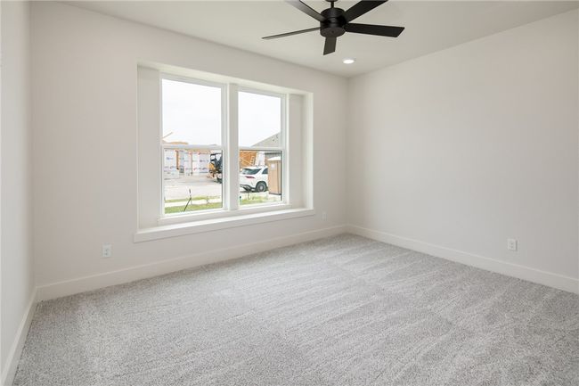 Unfurnished room with baseboards, carpet flooring, and ceiling fan | Image 23