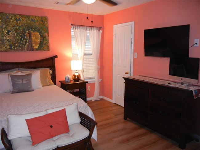 Another secondary bedroom is also very spacious and has a walk-in closet, ceiling fan and vinyl plank flooring. | Image 30