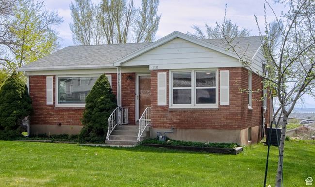 Bungalow featuring a front yard, brick siding, and central AC | Image 30