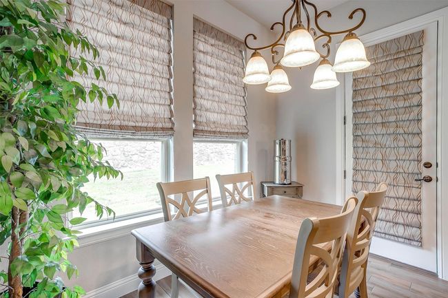 Dining area featuring a chandelier and wood finished floors | Image 19