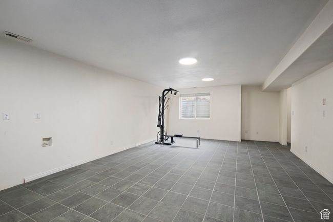 Exercise room featuring recessed lighting, visible vents, and dark tile patterned floors | Image 43