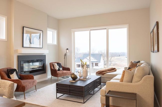 The family room opens up to the outdoors with an impressive 8-foot patio door, allowing for seamless transition between the indoor and outdoor spaces. Photos are from a previously built home; options and features will vary. | Image 8