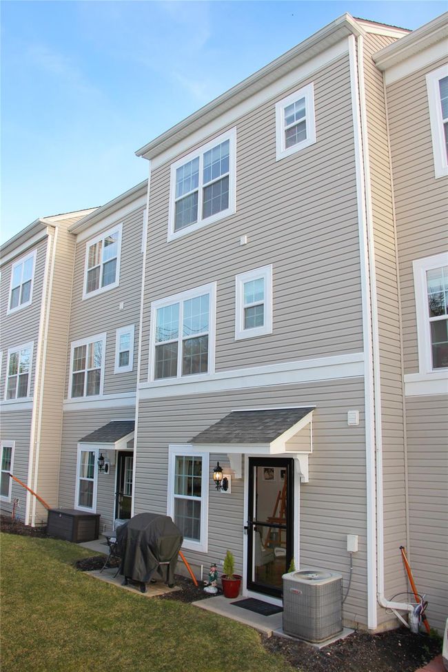 Rear view of property with a lawn and cooling unit | Image 24