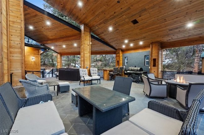 View of patio featuring a grill and an outdoor living space with a fire pit | Image 73