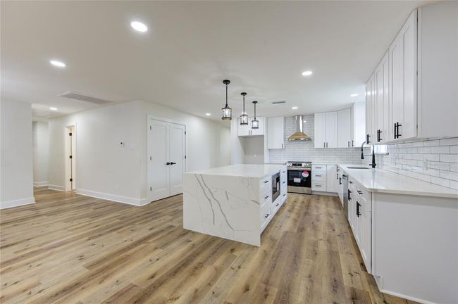 From the Breakfast Area to toward the kitchen shows the amount of space in these rooms. | Image 8