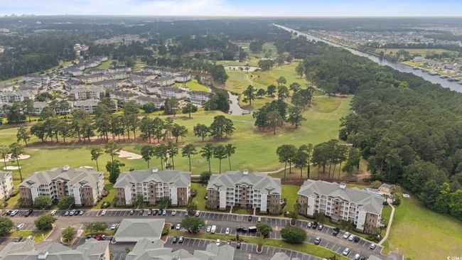Aerial overview of property's location featuring a large body of water and apartment complex | Image 18