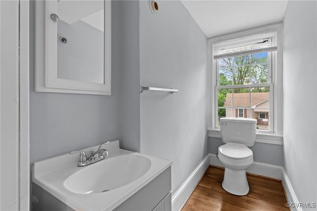 Bathroom with baseboards, wood finished floors, toilet, and vanity | Image 20
