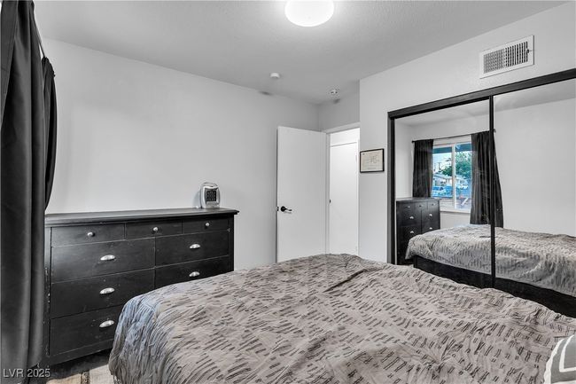 Bedroom with visible vents and a closet | Image 31