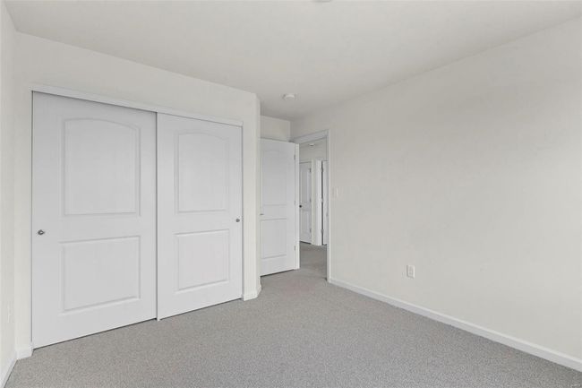 Unfurnished bedroom featuring light colored carpet and a closet | Image 12