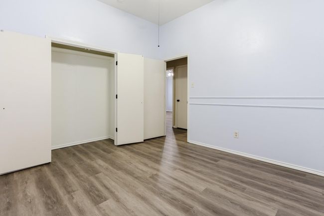 Unfurnished bedroom featuring baseboards and wood finished floors | Image 17