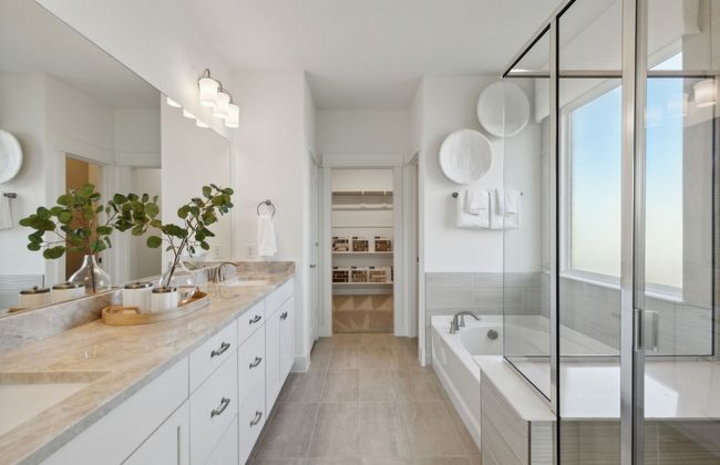 Elegant owner's bathroom with dual vanity *Photos of furnished model. Not actual home. Representative of floor plan. Some options and features may vary | Image 15