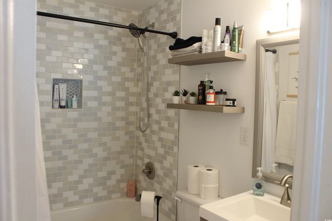 Bathroom featuring shower / bath combo and vanity | Image 10