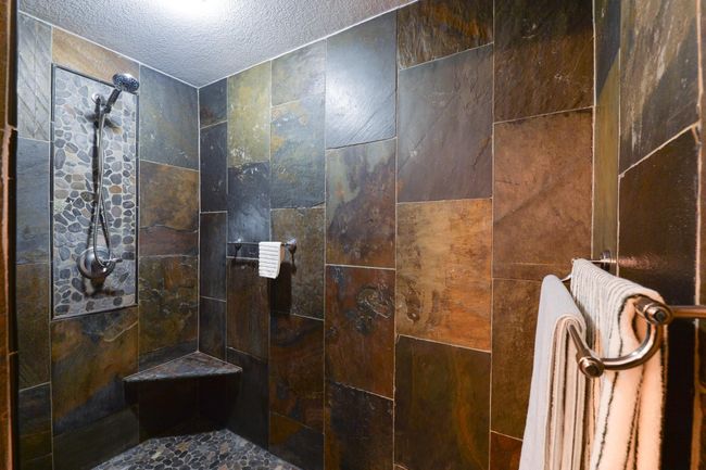 Beautiful tile work in the shower | Image 17