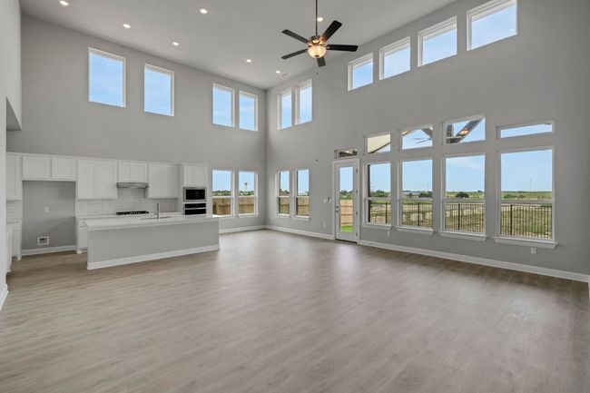 Unfurnished living room with a ceiling fan, light wood-type flooring, and recessed lighting | Image 5