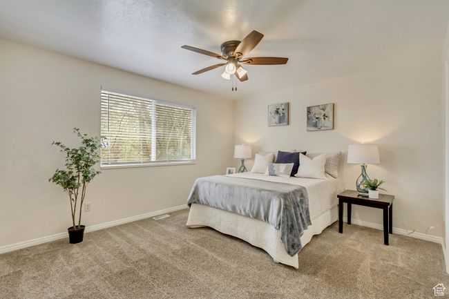 Carpeted bedroom featuring baseboards and ceiling fan | Image 8