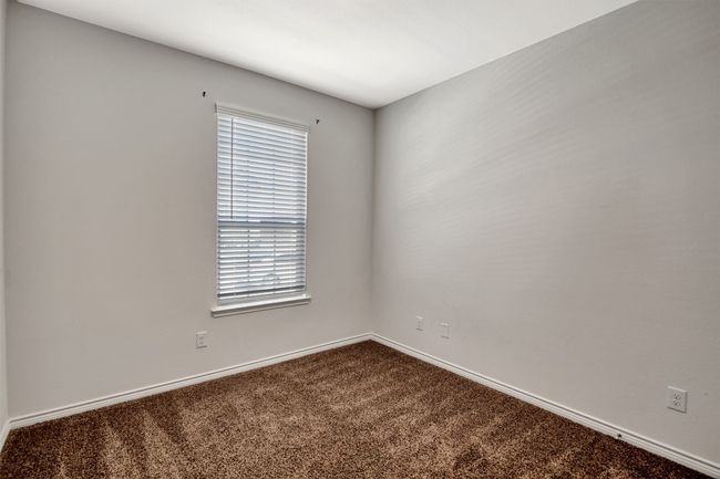 Spare room with dark carpet and baseboards | Image 24