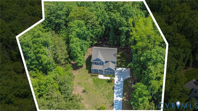 Aerial with property outline showing nearly 1-acre lot and wooded privacy. | Image 45