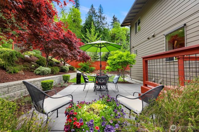 Spectacular private backyard, fully landscaped oasis, a small deck off the living room/kitchen that flows out to a spacious patio with a stone water feature. | Image 15