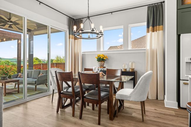 Natural light pours into the dining area, making it the perfect spot for morning coffee or evening meals. | Image 8