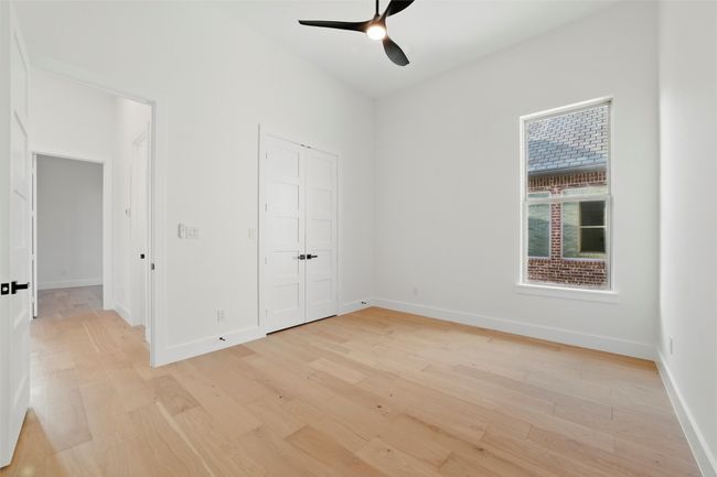 Unfurnished bedroom featuring baseboards, light wood-style flooring, and a closet | Image 23