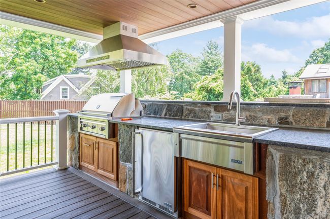 View of covered patio / terrace featuring a sink and area for grilling | Image 18