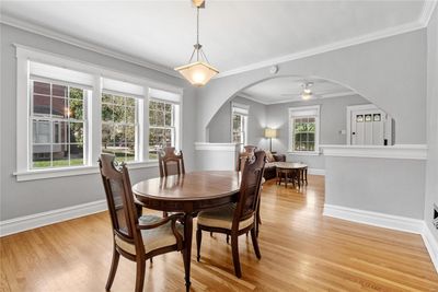 Dining room with crown molding, hardwood floors and a healthy amount of sunlight | Image 3