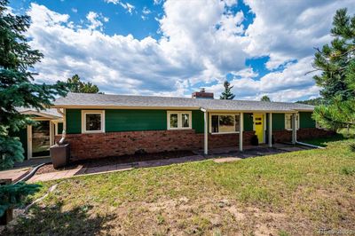 Welcome Home! This classic mid-century ranch style home in Hiwan Hills sits on a large sunny flat yard. | Image 1