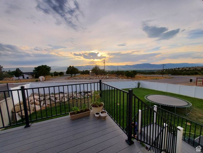 Wooden terrace featuring a yard, a mountain view, and fence | Image 8