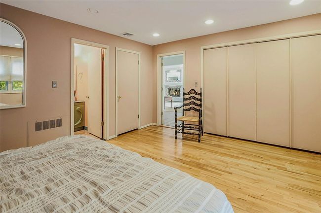 Bedroom featuring radiator, light wood-type flooring, recessed lighting, and a closet | Image 19