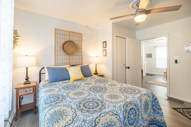 Bedroom featuring wood finished floors, baseboards, a closet, and a ceiling fan | Image 11