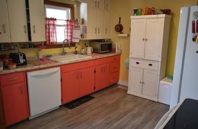 Kitchen with dark hardwood / wood-style floors, sink, and white appliances | Image 3