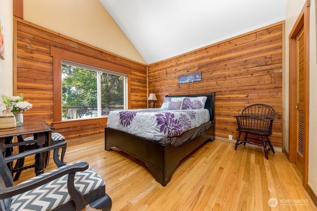 Primary bedroom with waterfront view, vaulted ceiling and walk-in closet. | Image 9