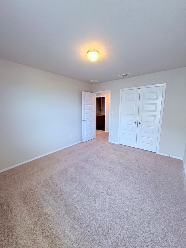Unfurnished bedroom featuring baseboards, carpet floors, visible vents, and a closet | Image 22